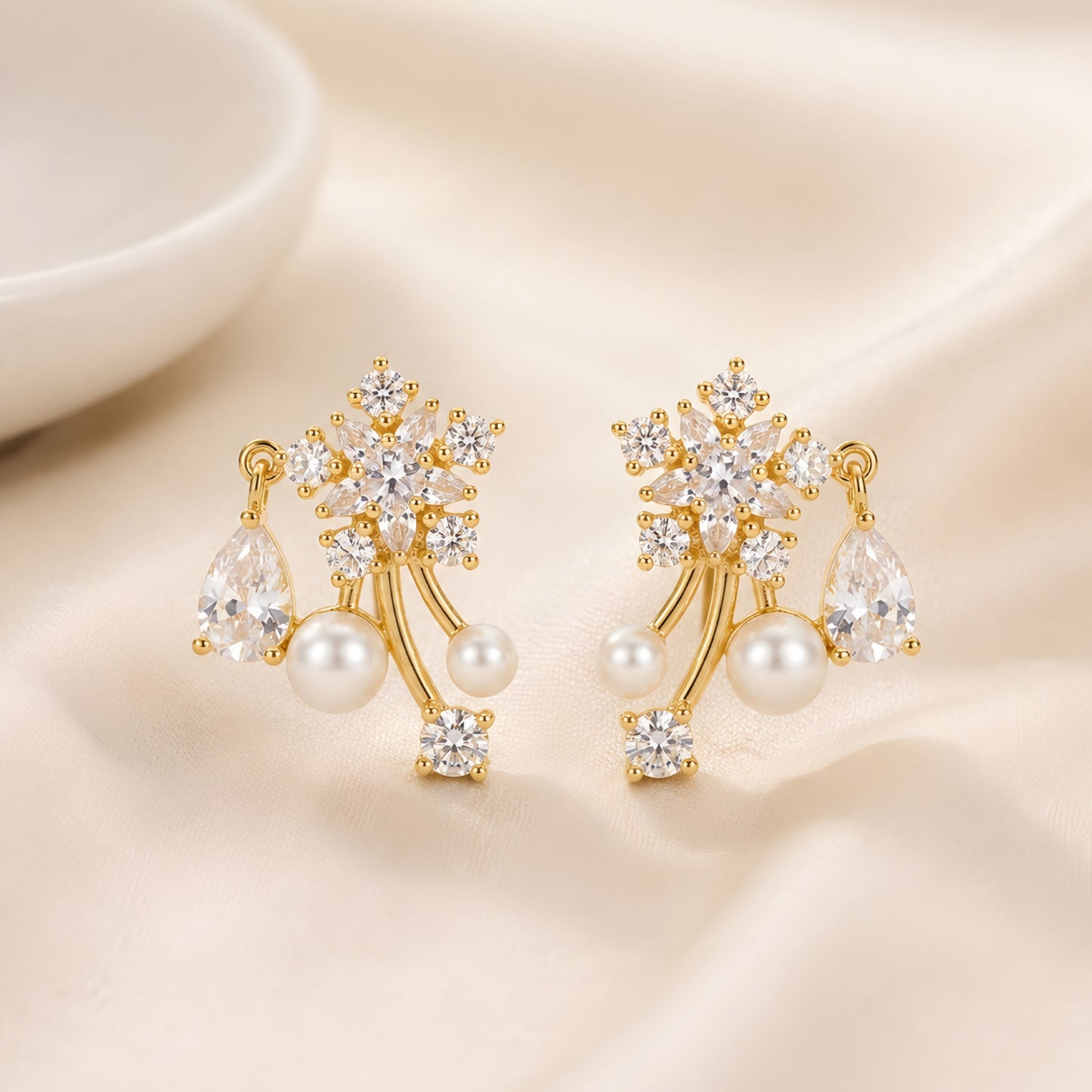 Woman wearing anti tarnish gold toned floral pearl push back earrings with sparkling stone detailing by MahanandaFJ Atelier.