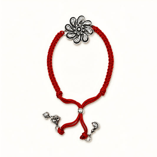 Sterling Silver Floral Lumba Rakhi for Bhabhi with oxidised flower centrepiece, red woven thread and hanging silver charms