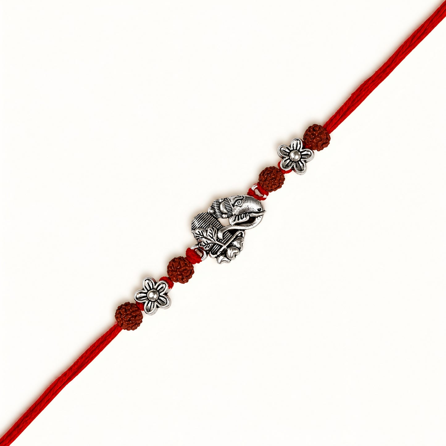 Silver Ganesh Shivling Rakhi with original Rudraksha beads, floral accents and red thread for Raksha Bandhan