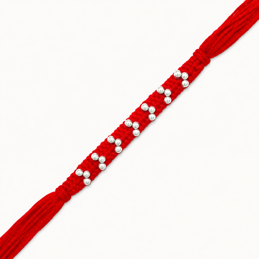 Silver handcrafted bead rakhi with polished silver beads on a braided red thread for Raksha Bandhan