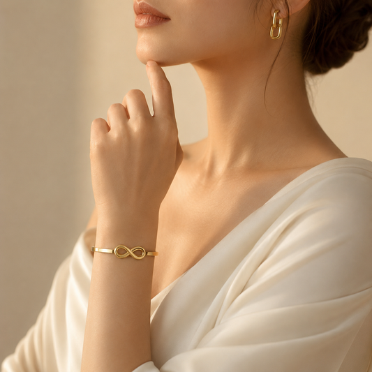 Minimalist gold infinity bangle bracelet with polished finish for women, elegant luxury everyday jewelry.