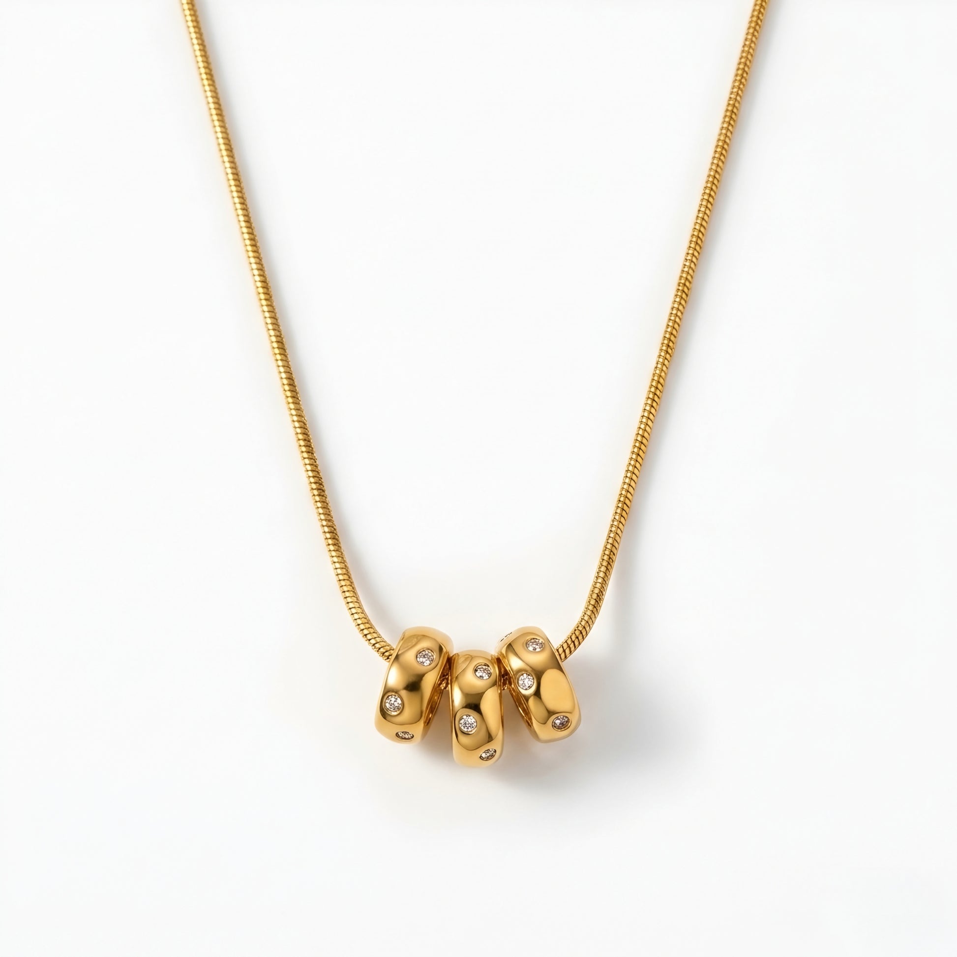 Modern gold-tone abstract pendant necklace for women featuring a polished minimalist designer pendant on a delicate chain.
