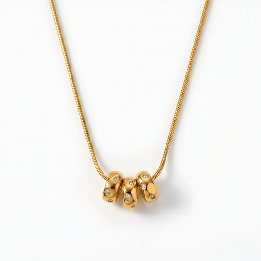 Modern gold-tone abstract pendant necklace for women featuring a polished minimalist designer pendant on a delicate chain.