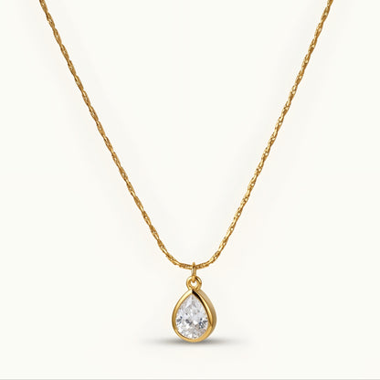 Elegant gold-tone teardrop pendant necklace with a sparkling stone, perfect for everyday wear and special occasions.