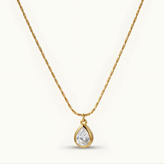 Elegant gold-tone teardrop pendant necklace with a sparkling stone, perfect for everyday wear and special occasions.