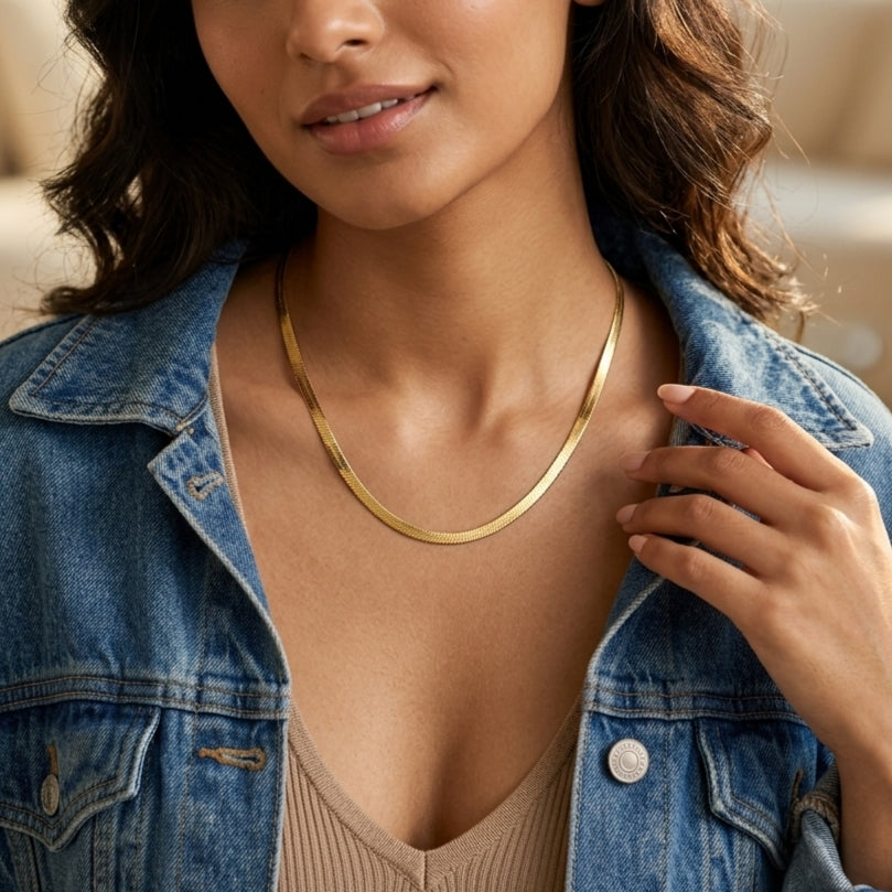 Minimalist gold herringbone chain necklace featuring a flat snake design with a polished finish for everyday wear and layering.
