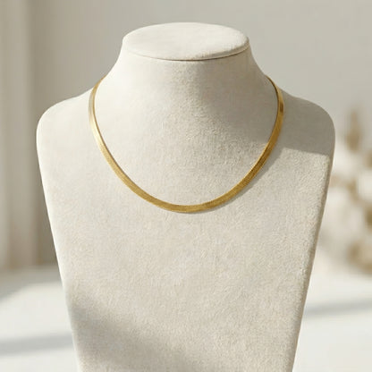 Minimalist gold herringbone chain necklace featuring a flat snake design with a polished finish for everyday wear and layering.
