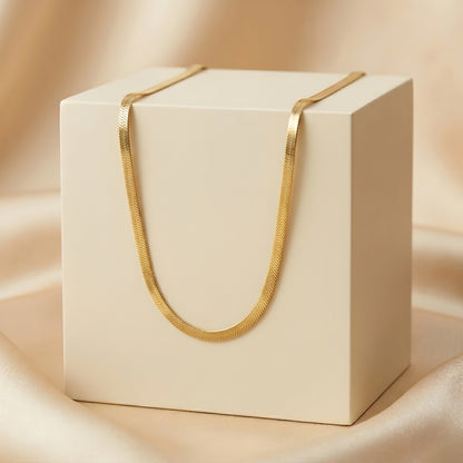 Minimalist gold herringbone chain necklace featuring a flat snake design with a polished finish for everyday wear and layering.