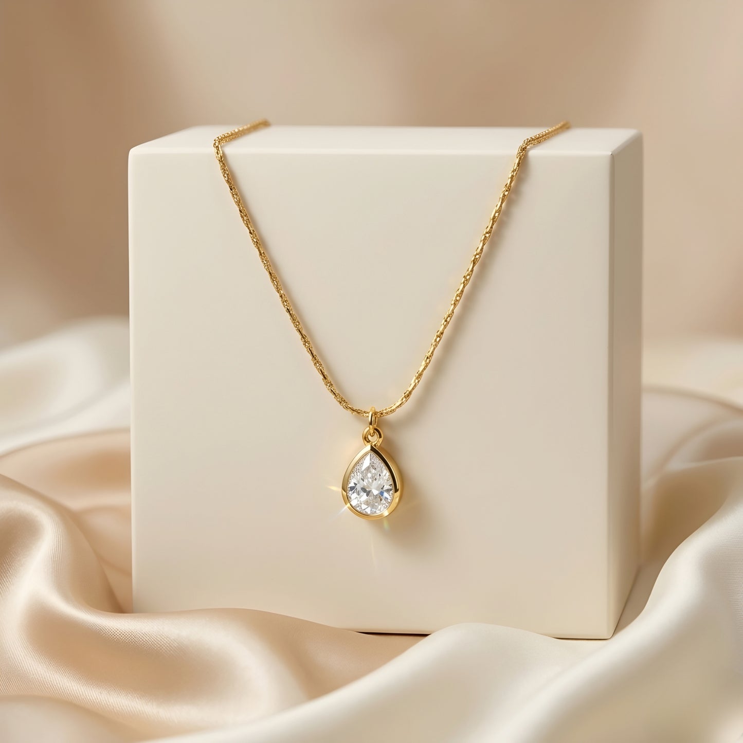 Elegant gold-tone teardrop pendant necklace with a sparkling stone, perfect for everyday wear and special occasions.