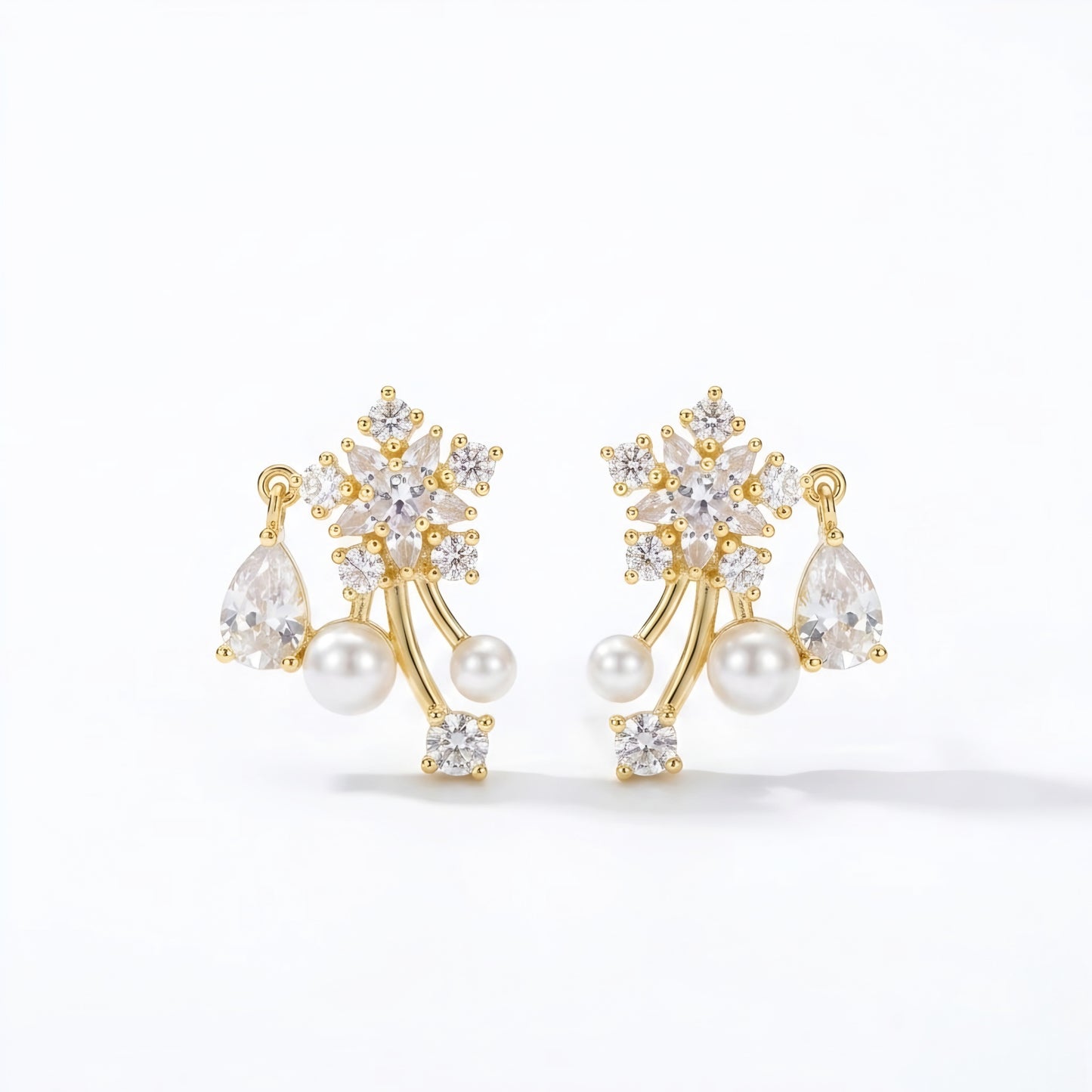 Woman wearing anti tarnish gold toned floral pearl push back earrings with sparkling stone detailing by MahanandaFJ Atelier.
