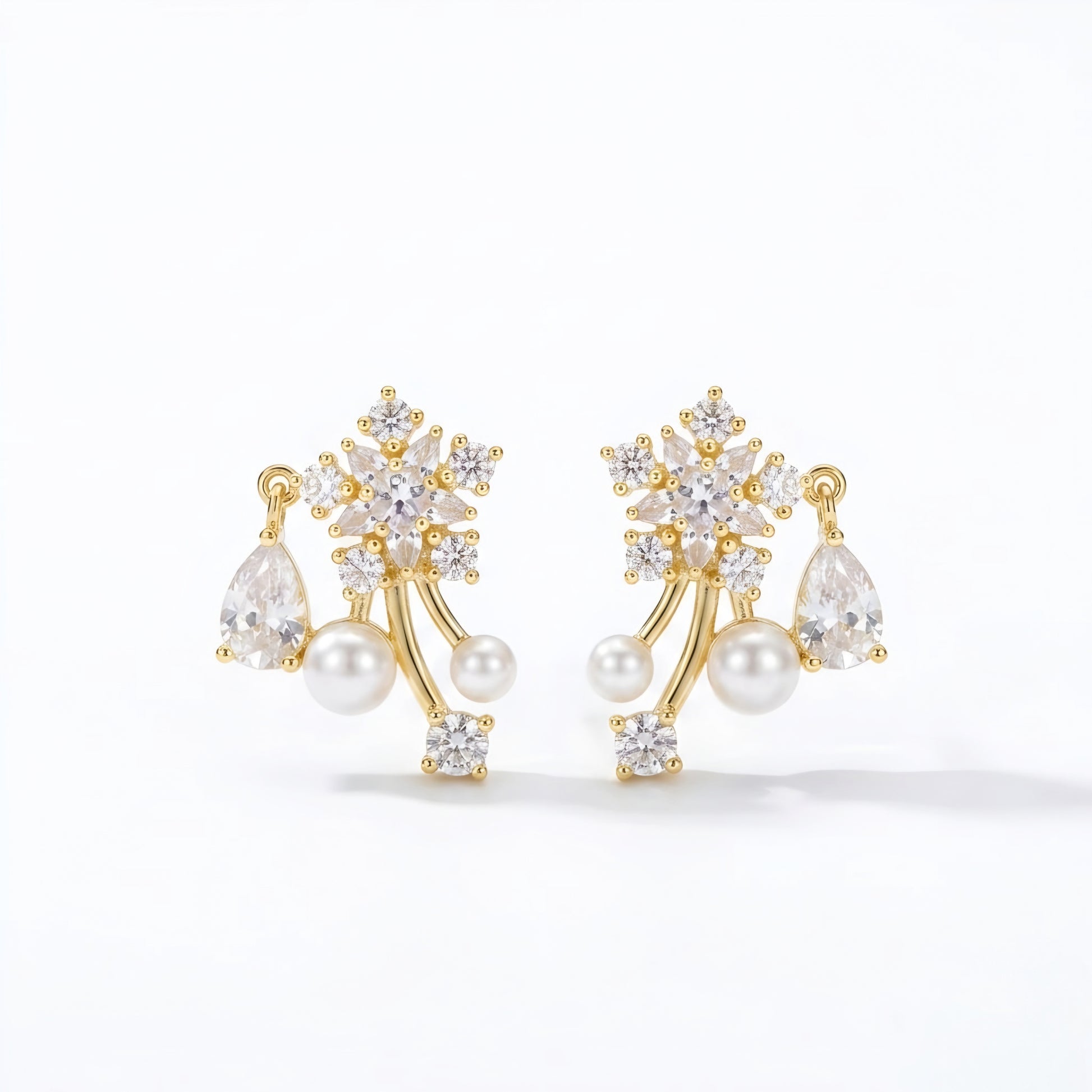 Woman wearing anti tarnish gold toned floral pearl push back earrings with sparkling stone detailing by MahanandaFJ Atelier.