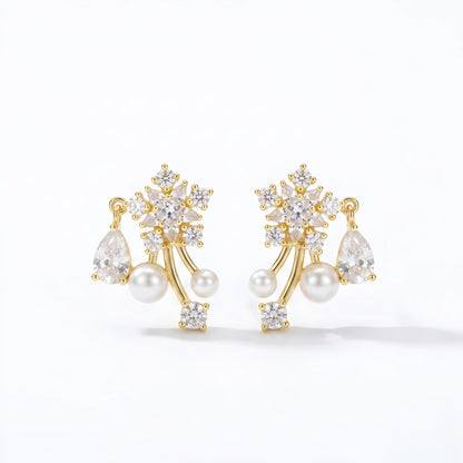 Woman wearing anti tarnish gold toned floral pearl push back earrings with sparkling stone detailing by MahanandaFJ Atelier.