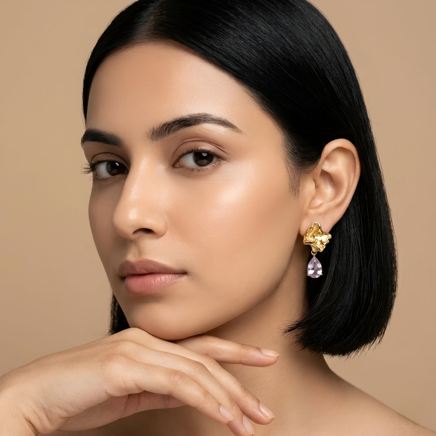 Woman wearing anti tarnish gold toned floral drop earrings with teardrop stone pendant by MahanandaFJ Atelier.