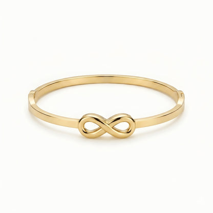 Minimalist gold infinity bangle bracelet with polished finish for women, elegant luxury everyday jewelry.