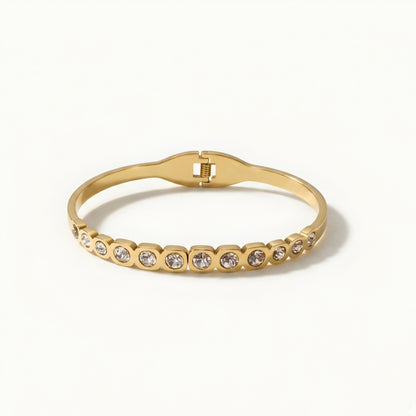 Elegant gold crystal bangle bracelet for women featuring bezel-set round crystals and a polished gold-tone finish.