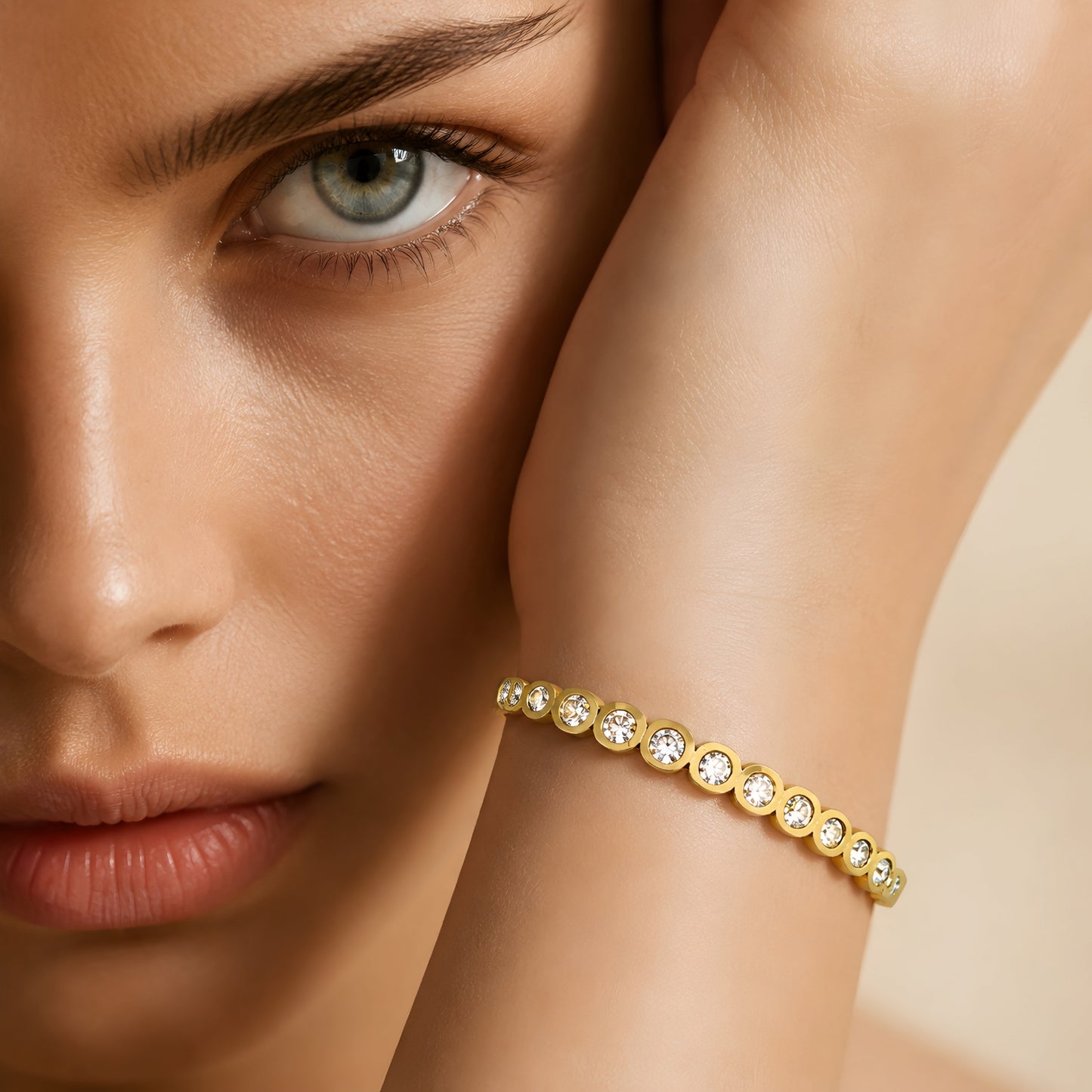 Elegant gold crystal bangle bracelet for women featuring bezel-set round crystals and a polished gold-tone finish.
