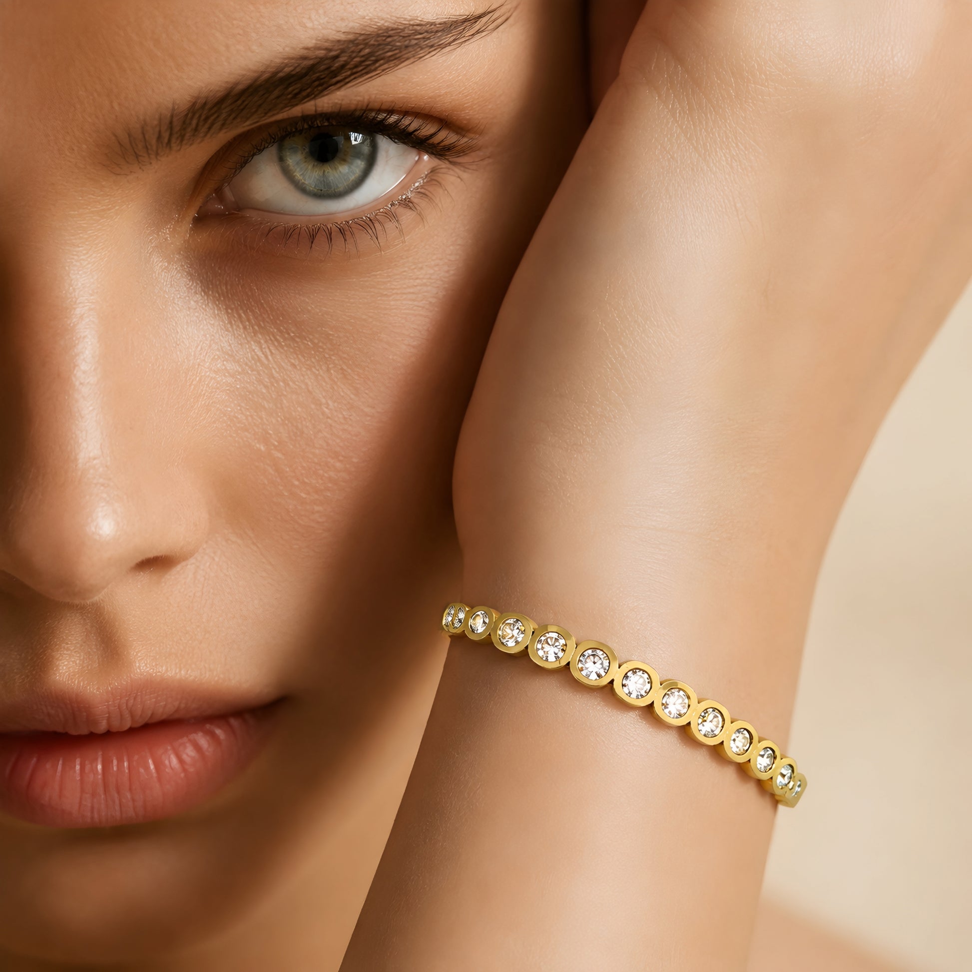 Elegant gold crystal bangle bracelet for women featuring bezel-set round crystals and a polished gold-tone finish.