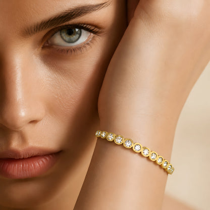 Elegant gold crystal bangle bracelet for women featuring bezel-set round crystals and a polished gold-tone finish.