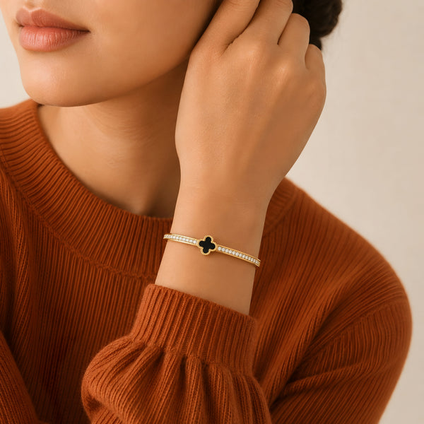 Gold plated black clover crystal bangle bracelet for women with sparkling zircon stones, worn on a model, perfect for daily wear and elegant styling.