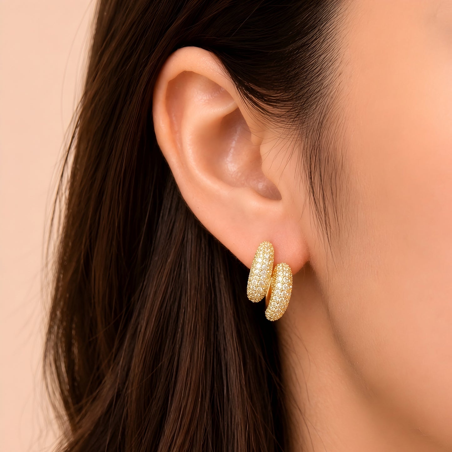 Woman wearing anti tarnish gold toned push back earrings with sparkling textured finish by MahanandaFJ Atelier.