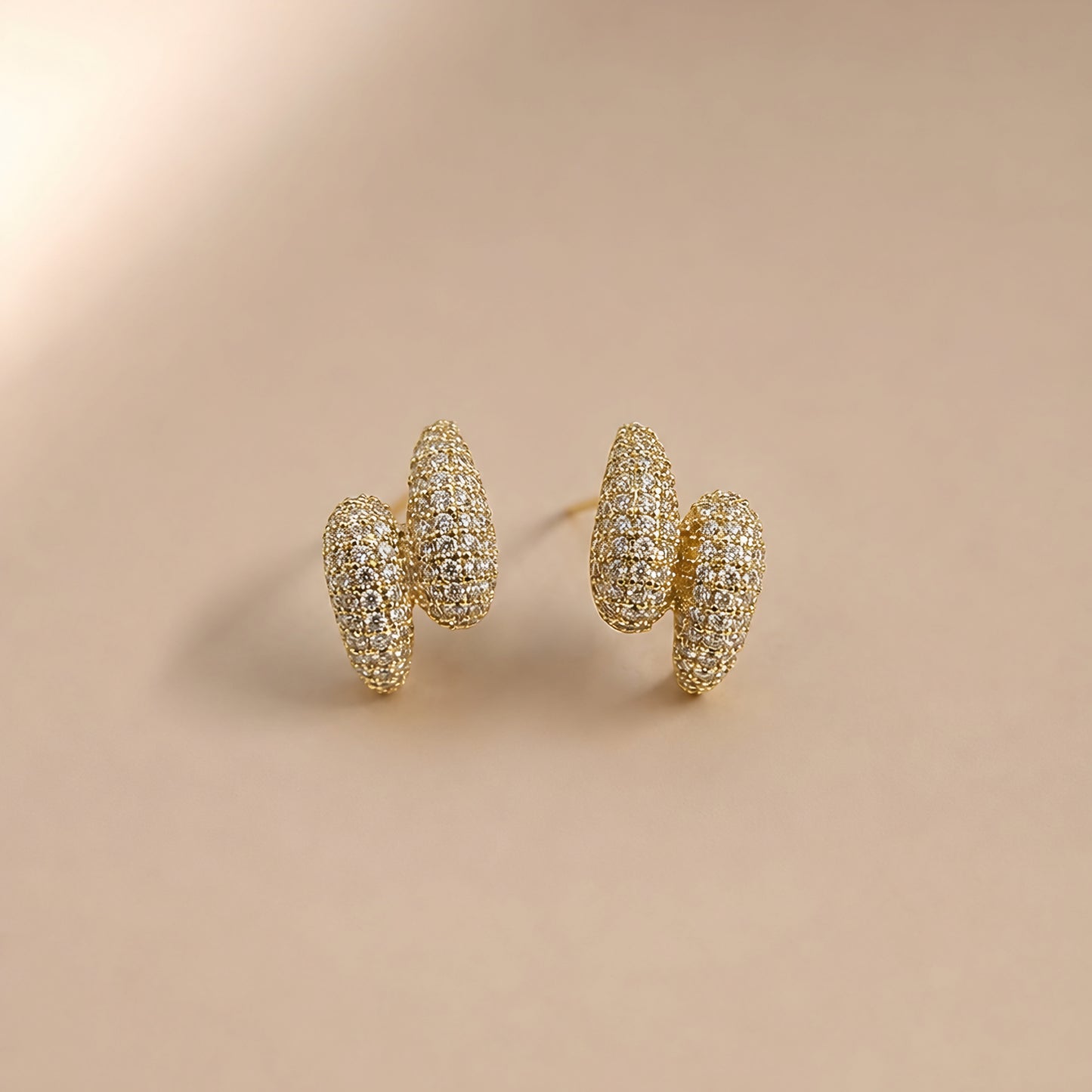Woman wearing anti tarnish gold toned push back earrings with sparkling textured finish by MahanandaFJ Atelier.