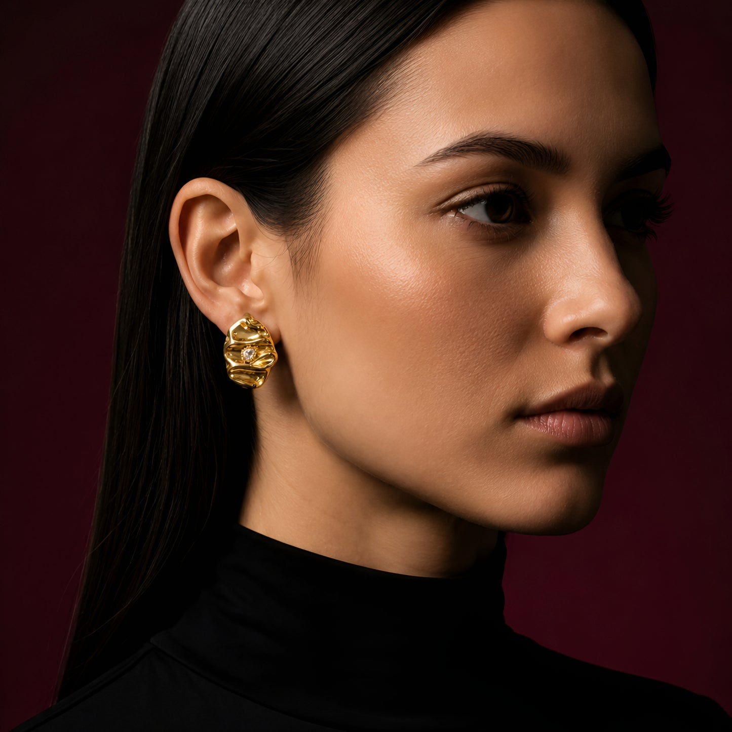 Woman wearing anti tarnish gold toned textured stud earrings with a modern crinkle design by MahanandaFJ Atelier.