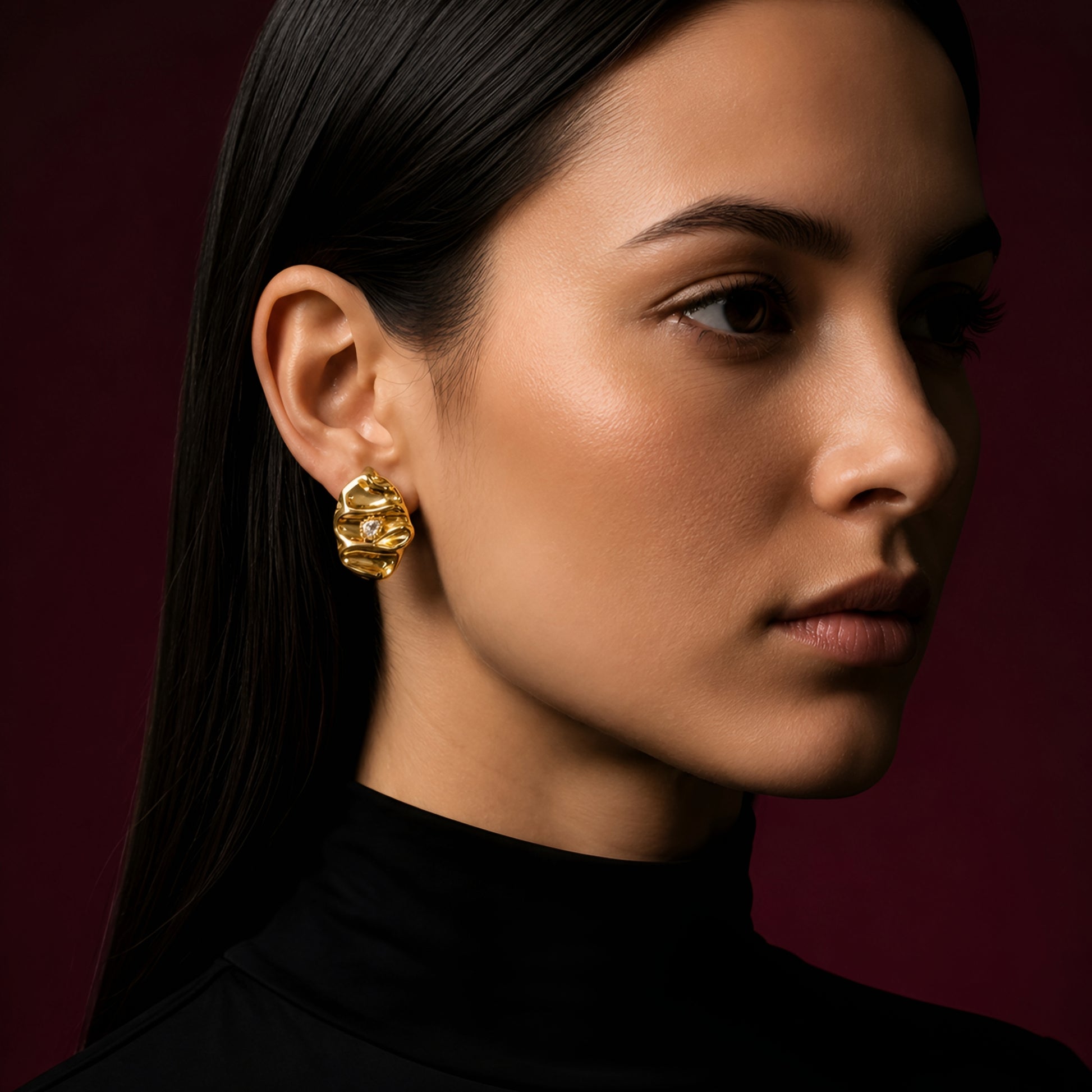 Woman wearing anti tarnish gold toned textured stud earrings with a modern crinkle design by MahanandaFJ Atelier.