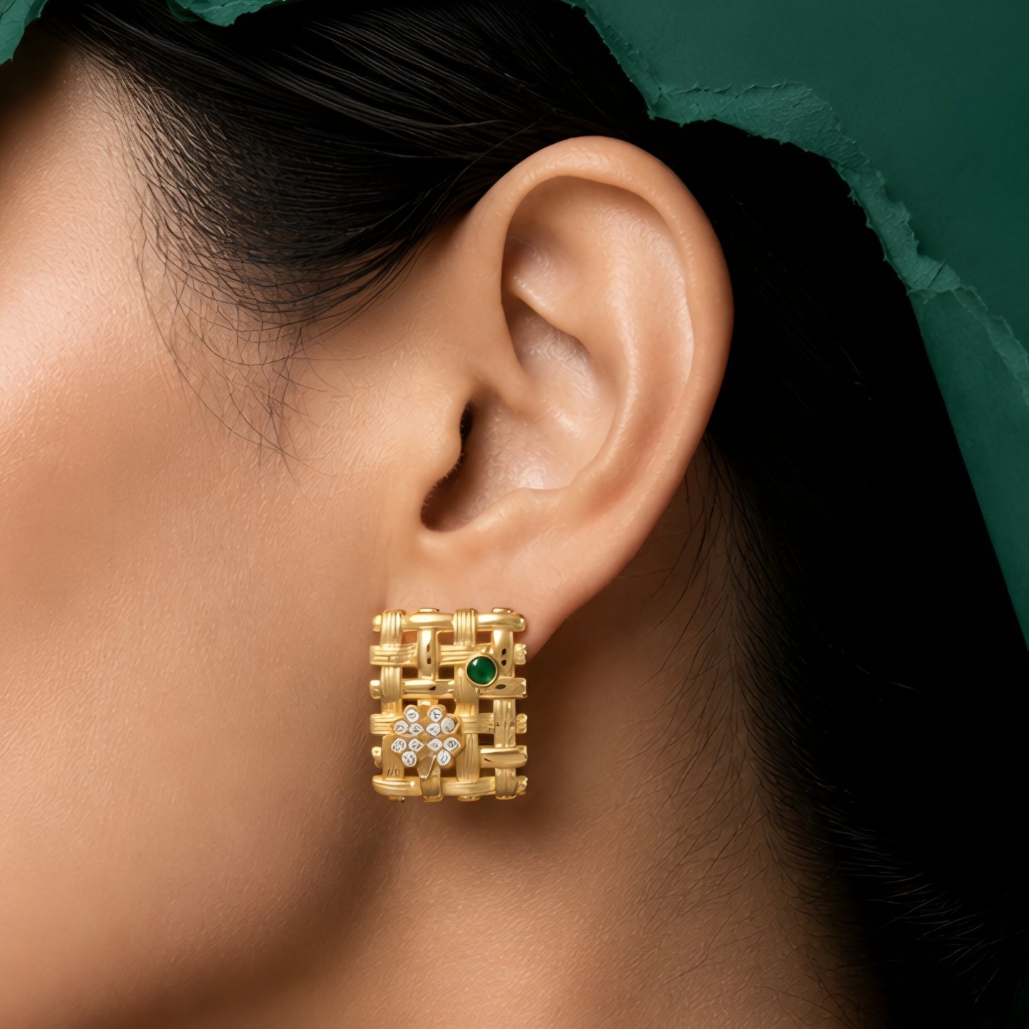Woman wearing anti tarnish gold toned geometric push back earrings with green stone detail by MahanandaFJ Atelier.