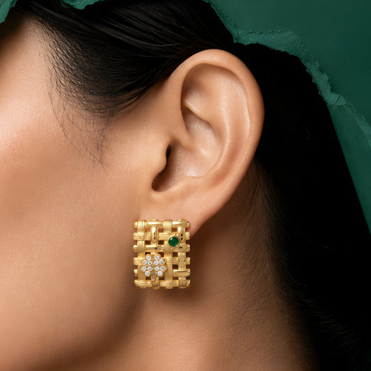 Woman wearing anti tarnish gold toned geometric push back earrings with green stone detail by MahanandaFJ Atelier.