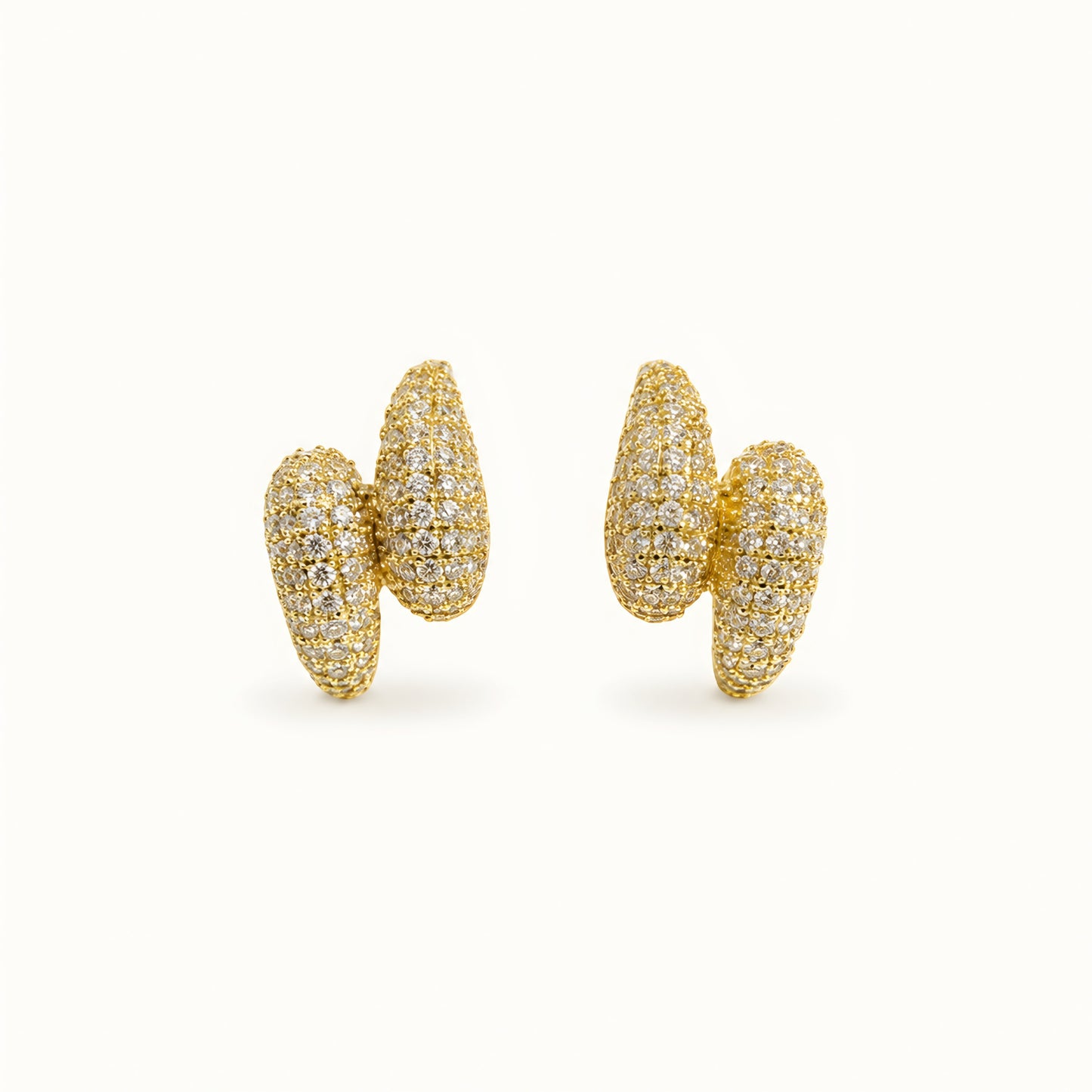 Woman wearing anti tarnish gold toned push back earrings with sparkling textured finish by MahanandaFJ Atelier.