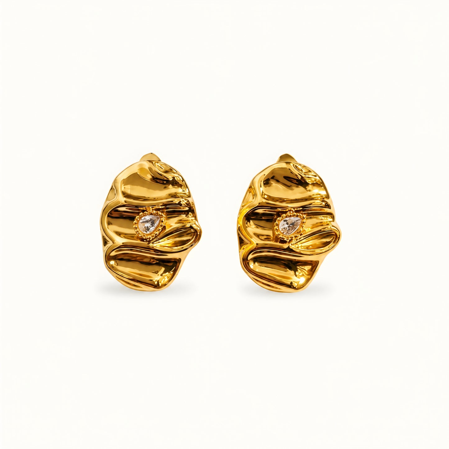 Woman wearing anti tarnish gold toned textured stud earrings with a modern crinkle design by MahanandaFJ Atelier.