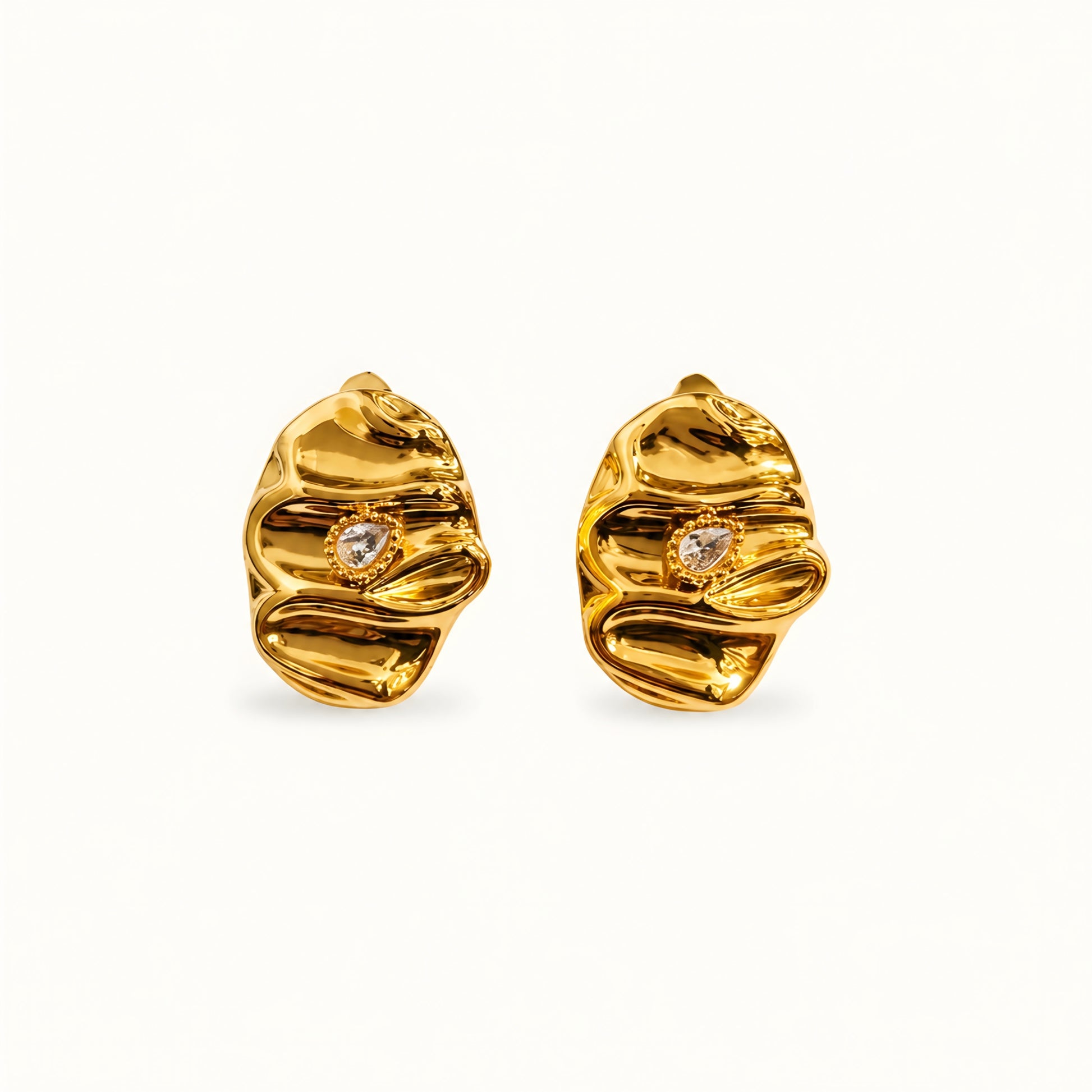 Woman wearing anti tarnish gold toned textured stud earrings with a modern crinkle design by MahanandaFJ Atelier.