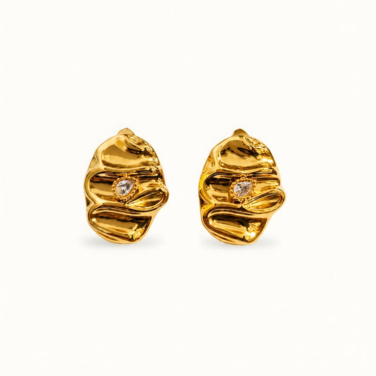 Woman wearing anti tarnish gold toned textured stud earrings with a modern crinkle design by MahanandaFJ Atelier.