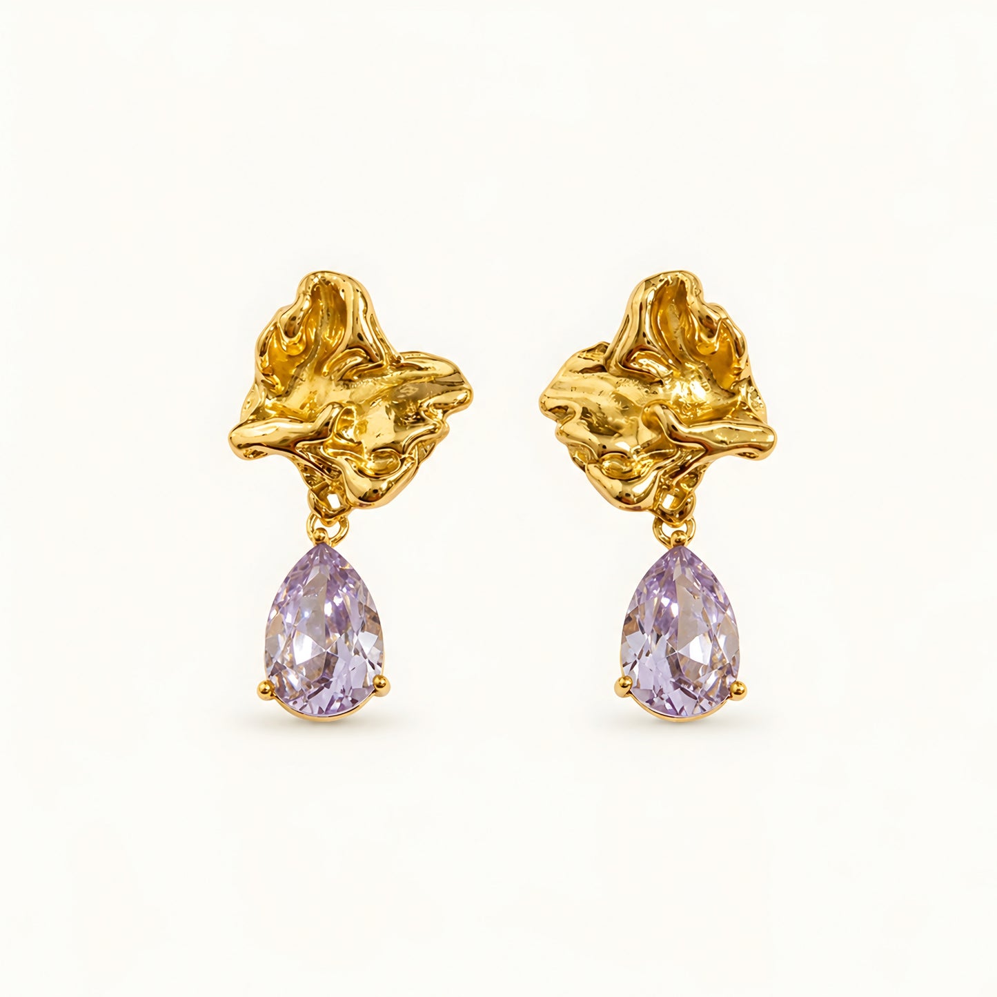 Woman wearing anti tarnish gold toned floral drop earrings with teardrop stone pendant by MahanandaFJ Atelier.