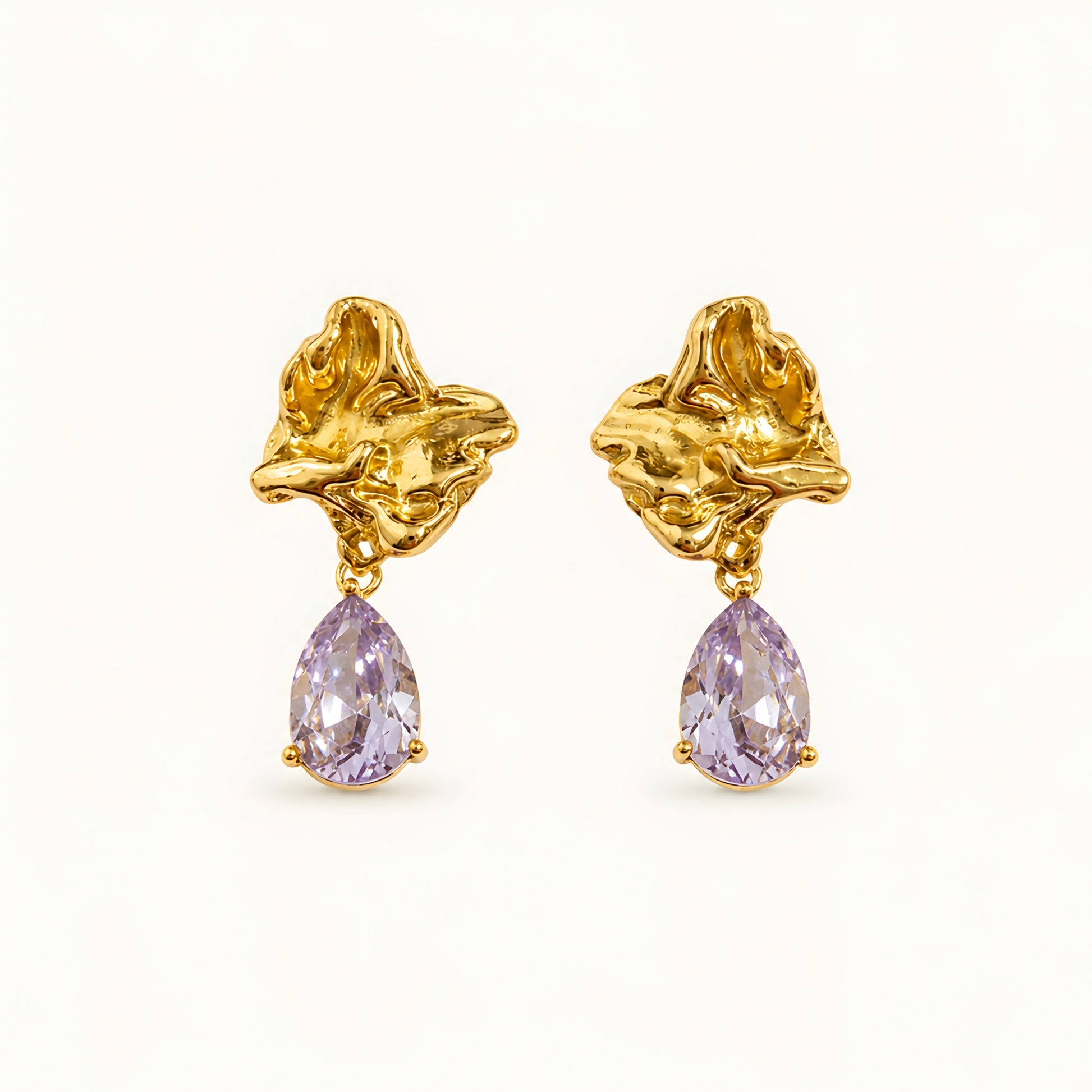 Woman wearing anti tarnish gold toned floral drop earrings with teardrop stone pendant by MahanandaFJ Atelier.