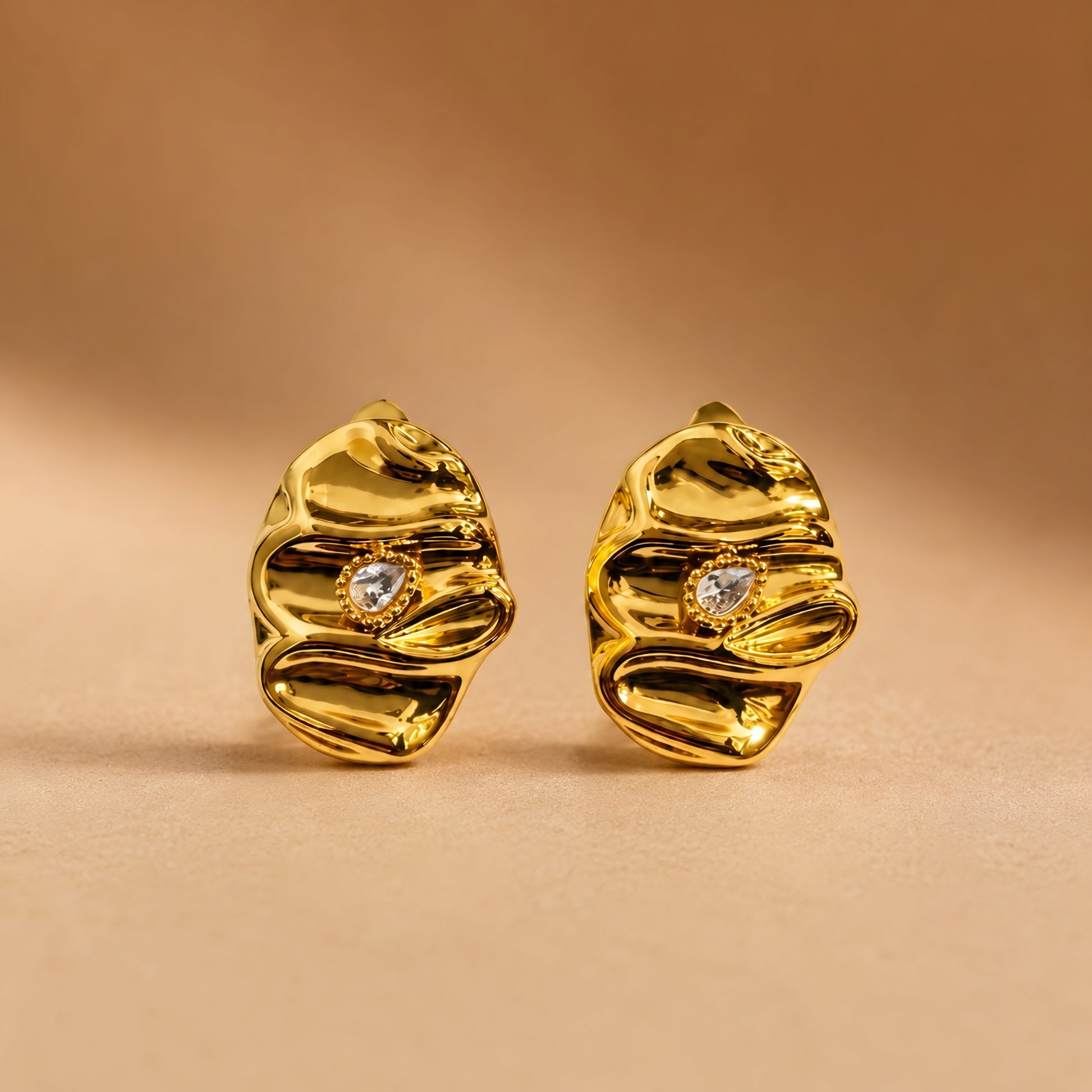 Woman wearing anti tarnish gold toned textured stud earrings with a modern crinkle design by MahanandaFJ Atelier.