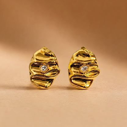 Woman wearing anti tarnish gold toned textured stud earrings with a modern crinkle design by MahanandaFJ Atelier.