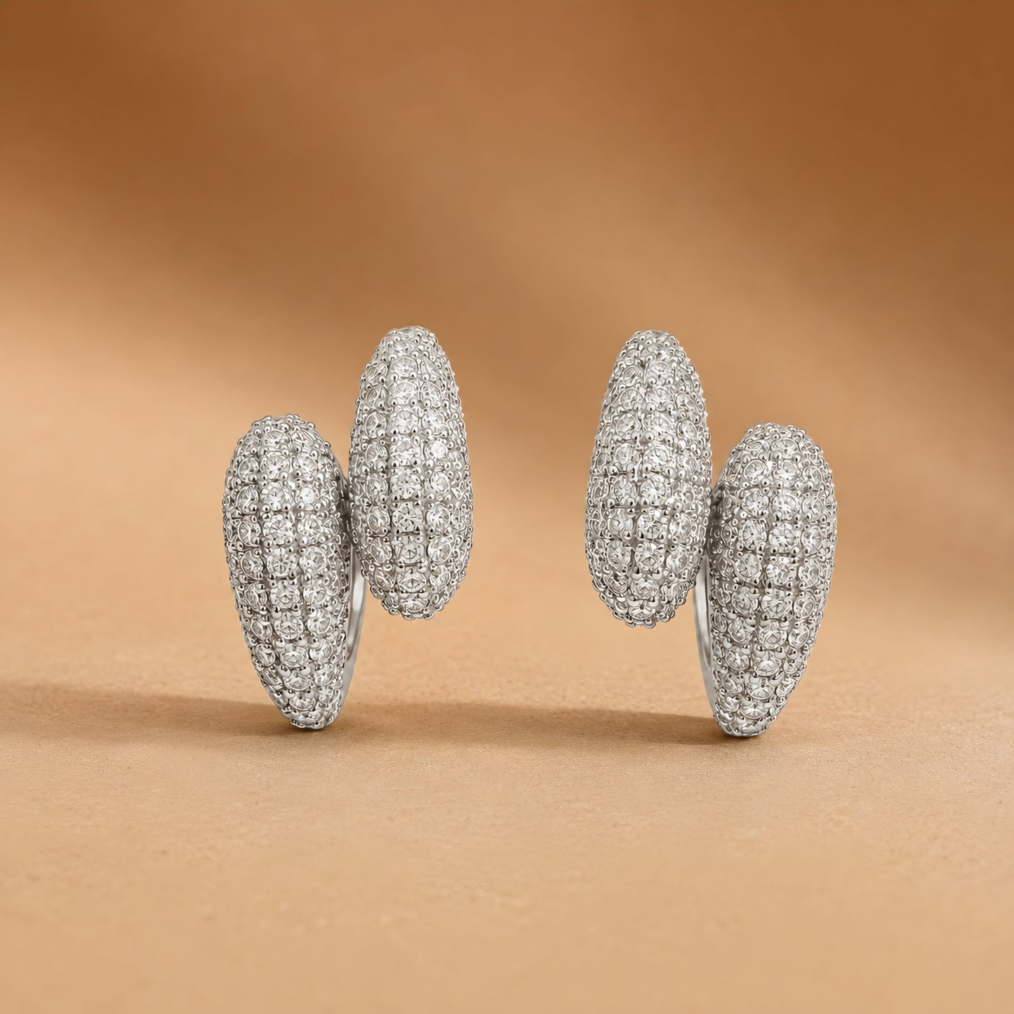 Silver toned anti tarnish pave stud earrings with diamond-look stones and push-back closure for women.