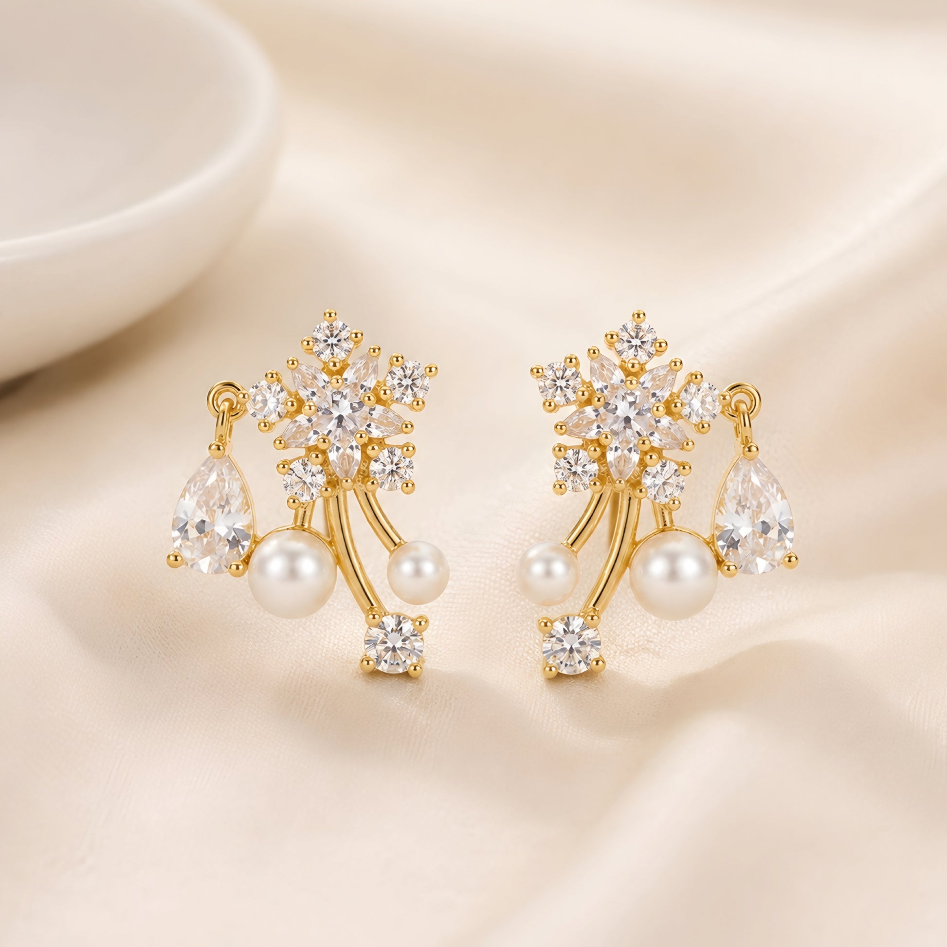 Woman wearing anti tarnish gold toned floral pearl push back earrings with sparkling stone detailing by MahanandaFJ Atelier.