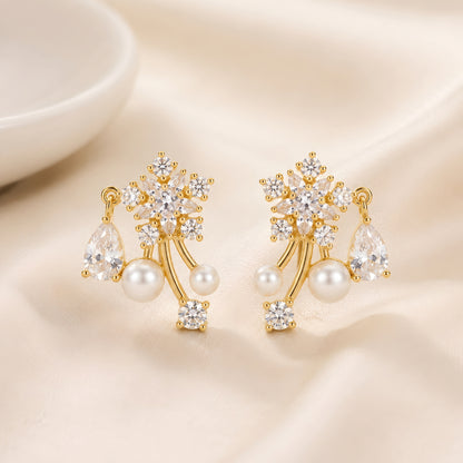 Woman wearing anti tarnish gold toned floral pearl push back earrings with sparkling stone detailing by MahanandaFJ Atelier.