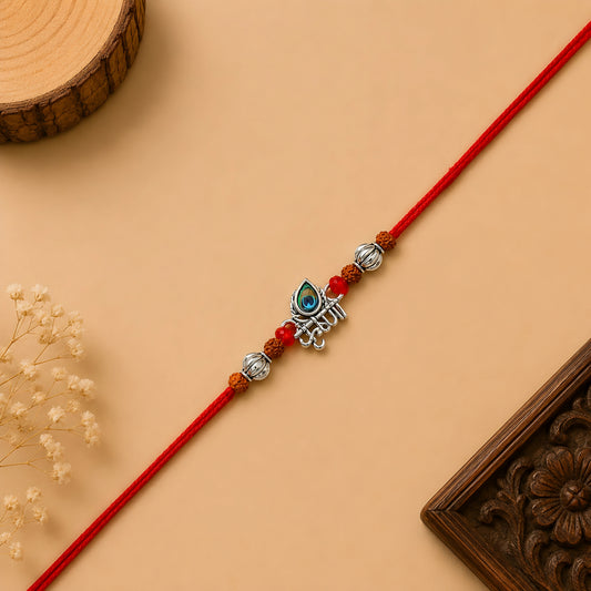 Silver Krishna flute rakhi with peacock feather, original Rudraksha beads and red thread for Raksha Bandhan