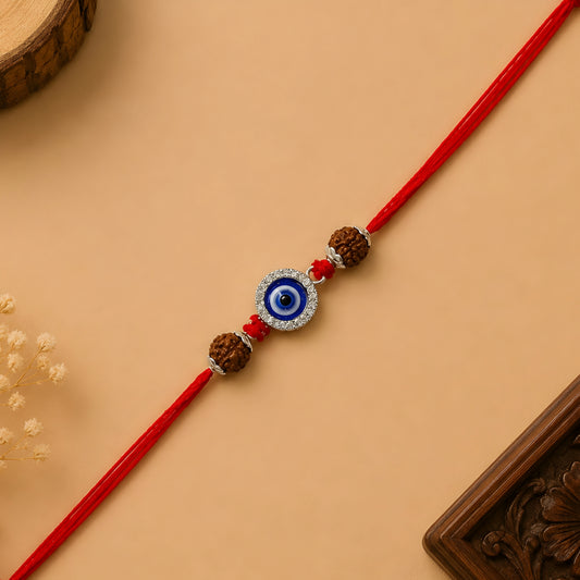 Silver Evil Eye Rakhi with blue Nazar charm, original Rudraksha beads and handcrafted red thread for Raksha Bandhan