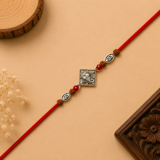 Silver Ganesh Om Rudraksha Rakhi with original Rudraksha beads, Om charms, and handcrafted red thread for Raksha Bandhan