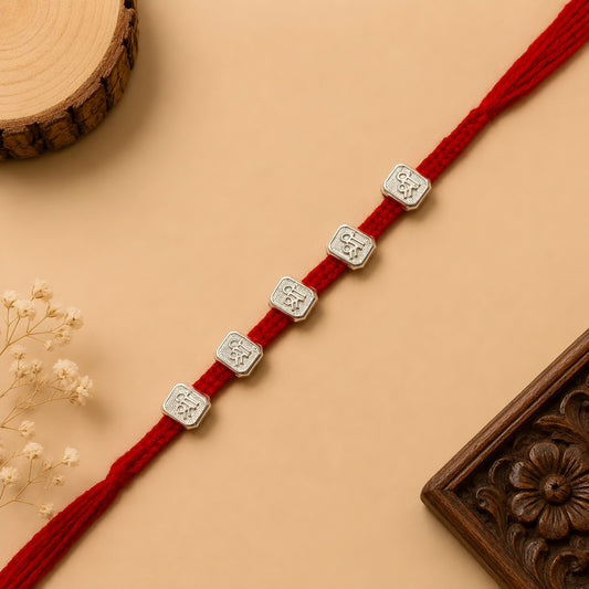 Silver Panch Shri Rakhi featuring five Shri silver charms on a handcrafted red braided thread for Raksha Bandhan