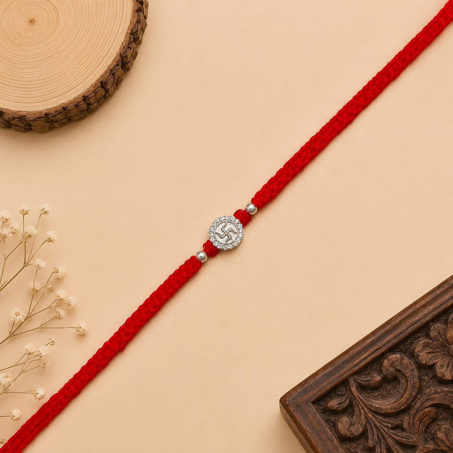 Silver Swastik stone rakhi with sacred Swastik symbol on a handcrafted red braided thread for Raksha Bandhan