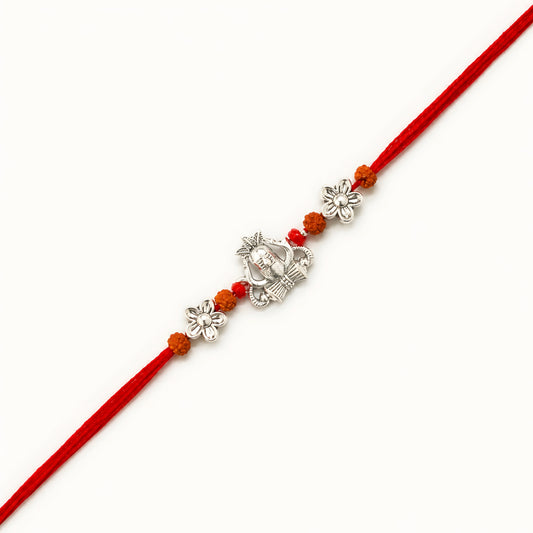 Handcrafted sterling silver Shiva rakhi with Mahadev-inspired centerpiece, rudraksha beads, floral silver accents and premium red thread