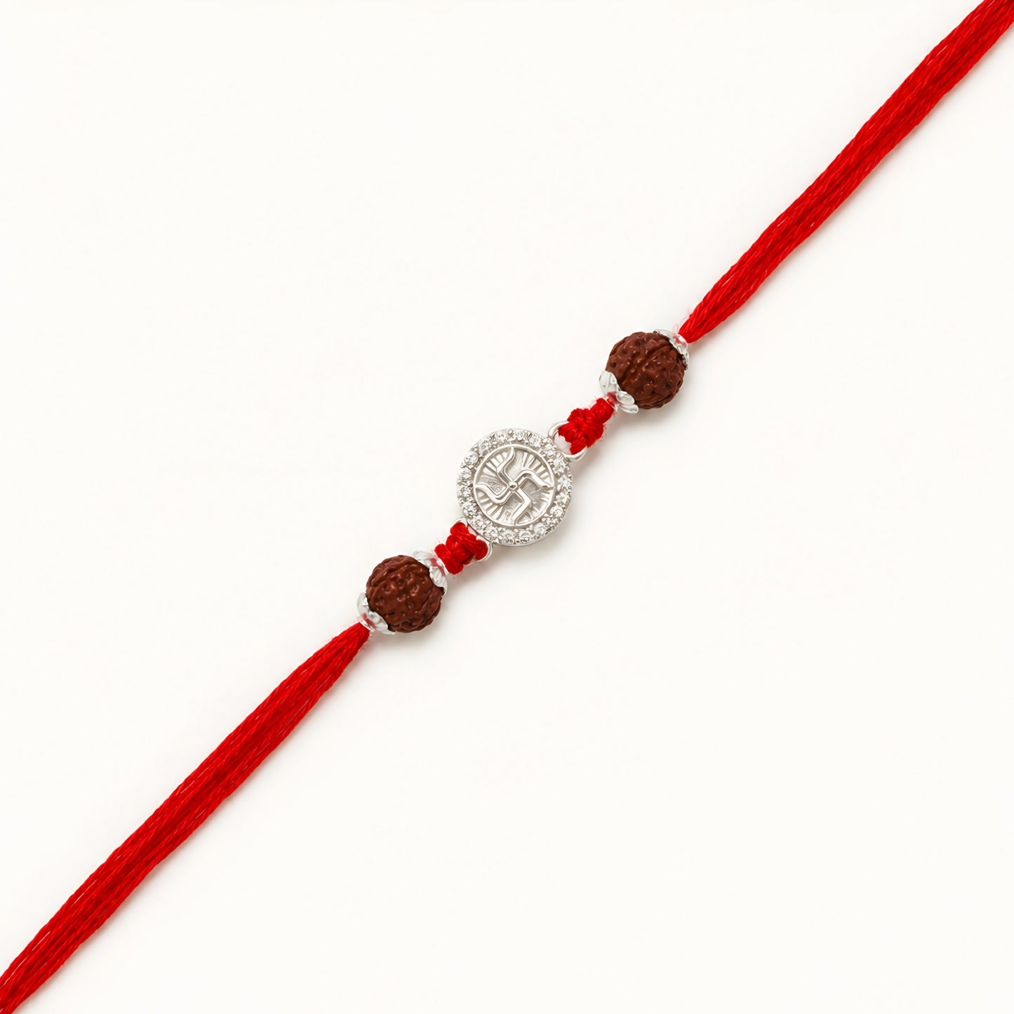 Handcrafted sterling silver Swastik rakhi with natural rudraksha beads and premium red thread for Raksha Bandhan