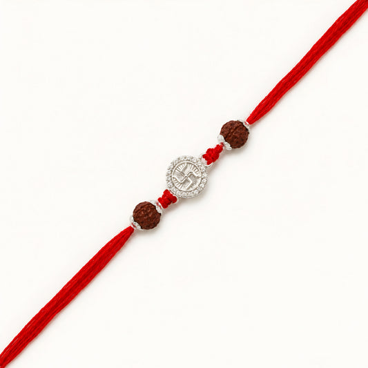 Handcrafted sterling silver Swastik rakhi with natural rudraksha beads and premium red thread for Raksha Bandhan