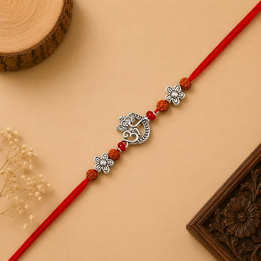 Handcrafted 925 silver Ganesh rakhi with crescent moon design, rudraksha beads, floral silver spacers and red thread for Raksha Bandhan