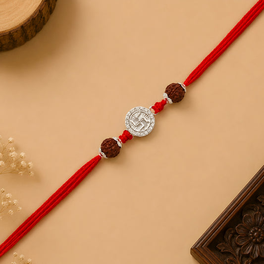Handcrafted sterling silver Swastik rakhi with natural rudraksha beads and premium red thread for Raksha Bandhan